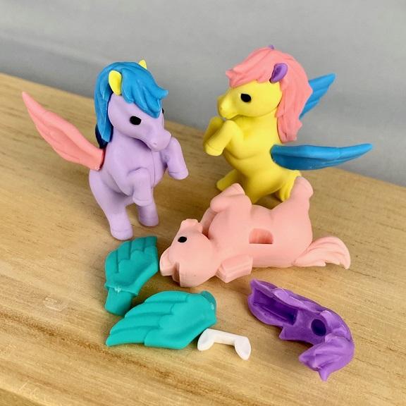Front view of the lavender and yellow Puzzle Eraser-Unicorn &amp; Pegasus with the pink one in front broken apart to put together.