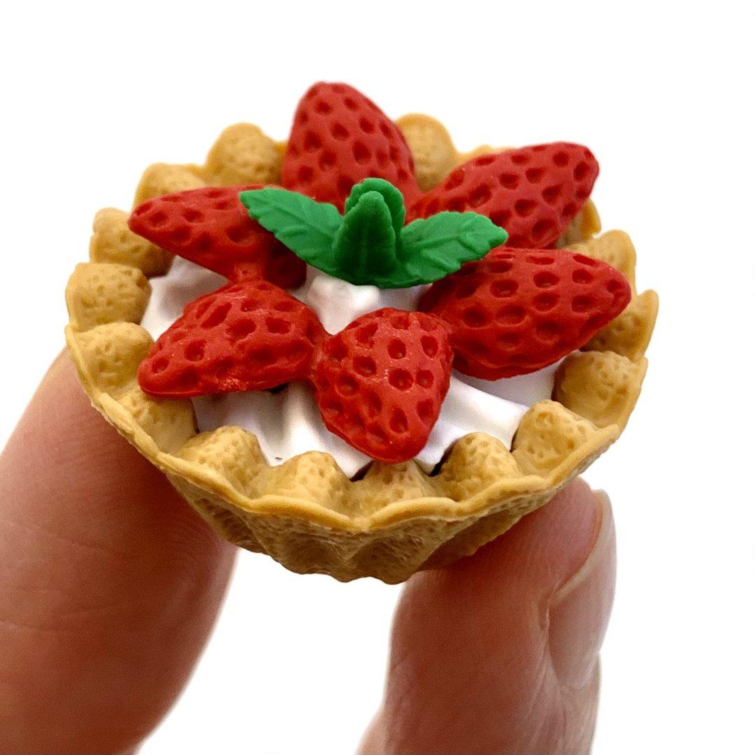 Front view of the strawberry pie dessert in someone&#39;s fingers from the Puzzle Eraser-Dessert.