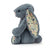 Side view of the dusky blue bunny sitting.