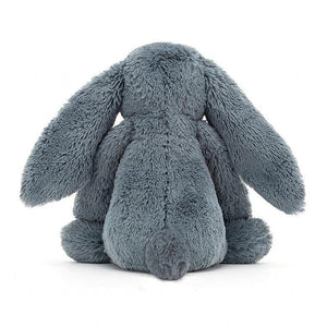 Rear view of the dusky blue bunny sitting.