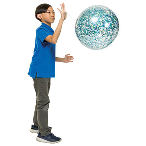 Child in a blue shirt playing with clear punch balloon