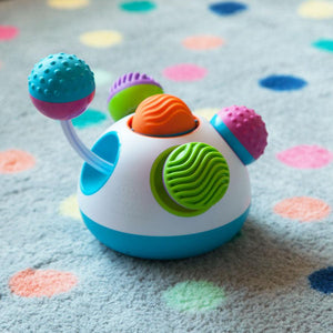 Toy with blue pink ball pulled out, demonstrating that it pulls the opposite ball towards the center