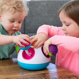 Two young children playing together with toy