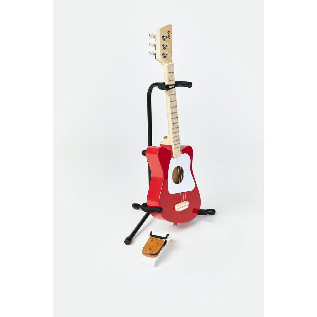 Front view of the mini red guitar on a stand.