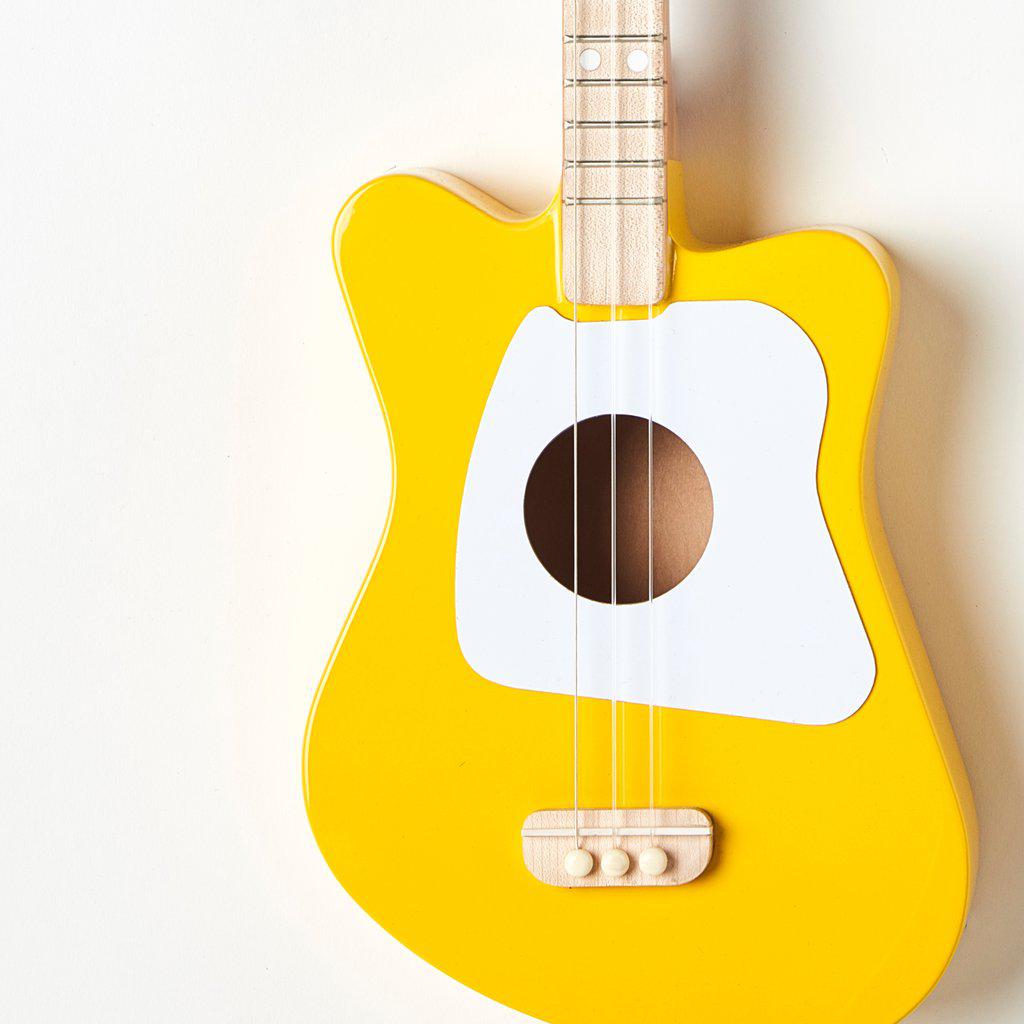 Front view of a section of the mini yellow guitar.