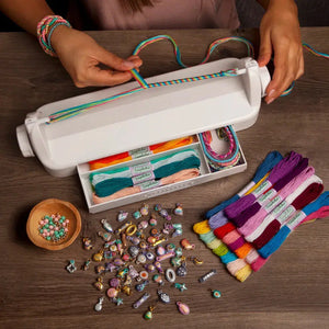 Top view of a person using the loopdedoo loom to make a bracelet.