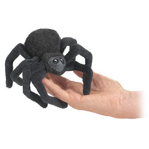 Black fuzzy spider finger puppet, with a sweet face, held by an adult