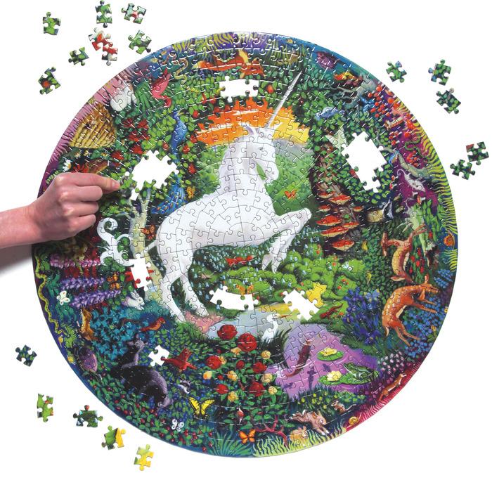Box featuring image of a white unicorn rearing up in the center of a colorful garden with animals, with a detail of pieces assembled with a red fox on them.