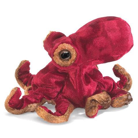 Red octopus finger puppet in hand. 