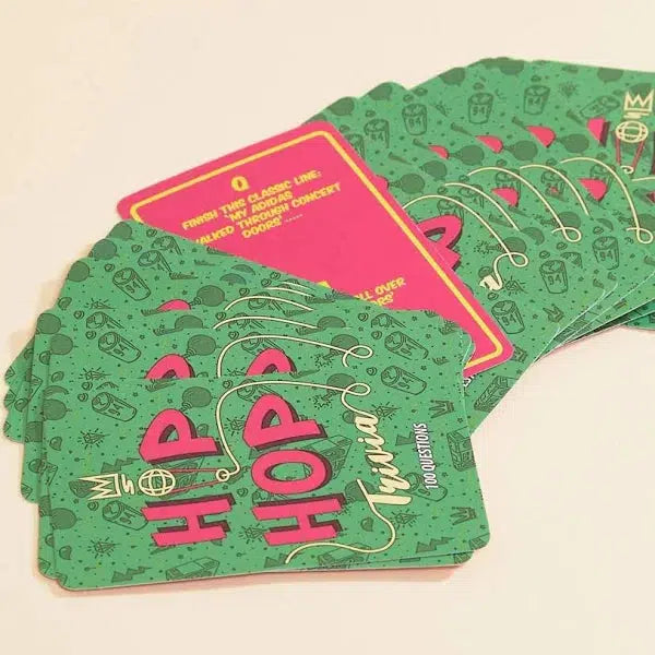 The back of the green trivia cards are spread out face down