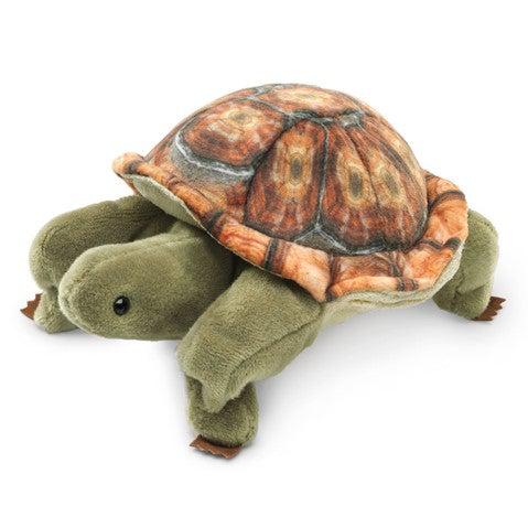 Green tortoise finger puppet, with a sweet face, quarter front view.