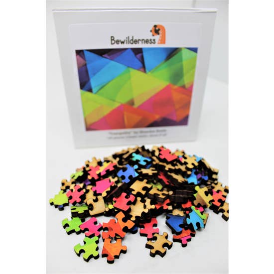 Puzzle box with partially assembled puzzle featuring translucent, rainbow-colored, overlapping triangles.