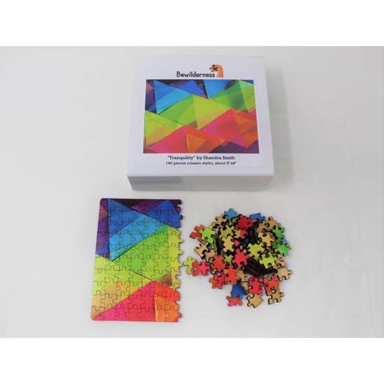 Box with half-assembled puzzle in lower left and puzzle pieces on the lower right.