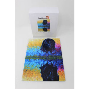 Box with finished puzzle, depicting a black raven admiring his own reflection on a blue, yellow, orange and magenta, painterly background.